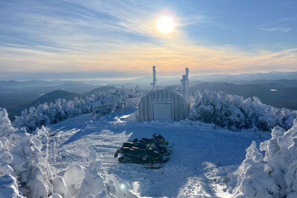 Snowmobiles at the top of Coburn Mountain